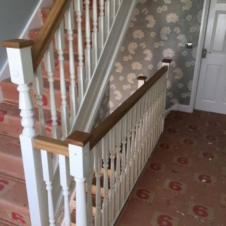 traditional white wooden staircase and banisters