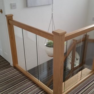 wood and glass staircase and banisters