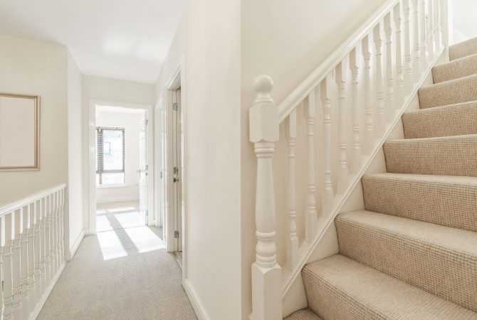 white wooden banisters in white home