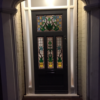 black front door with decorative stain glass